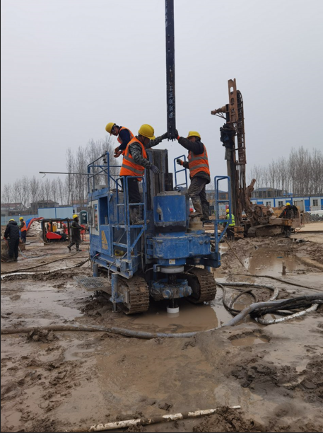 Workers installing drill pipe on SJL-120 rig for jet grouting